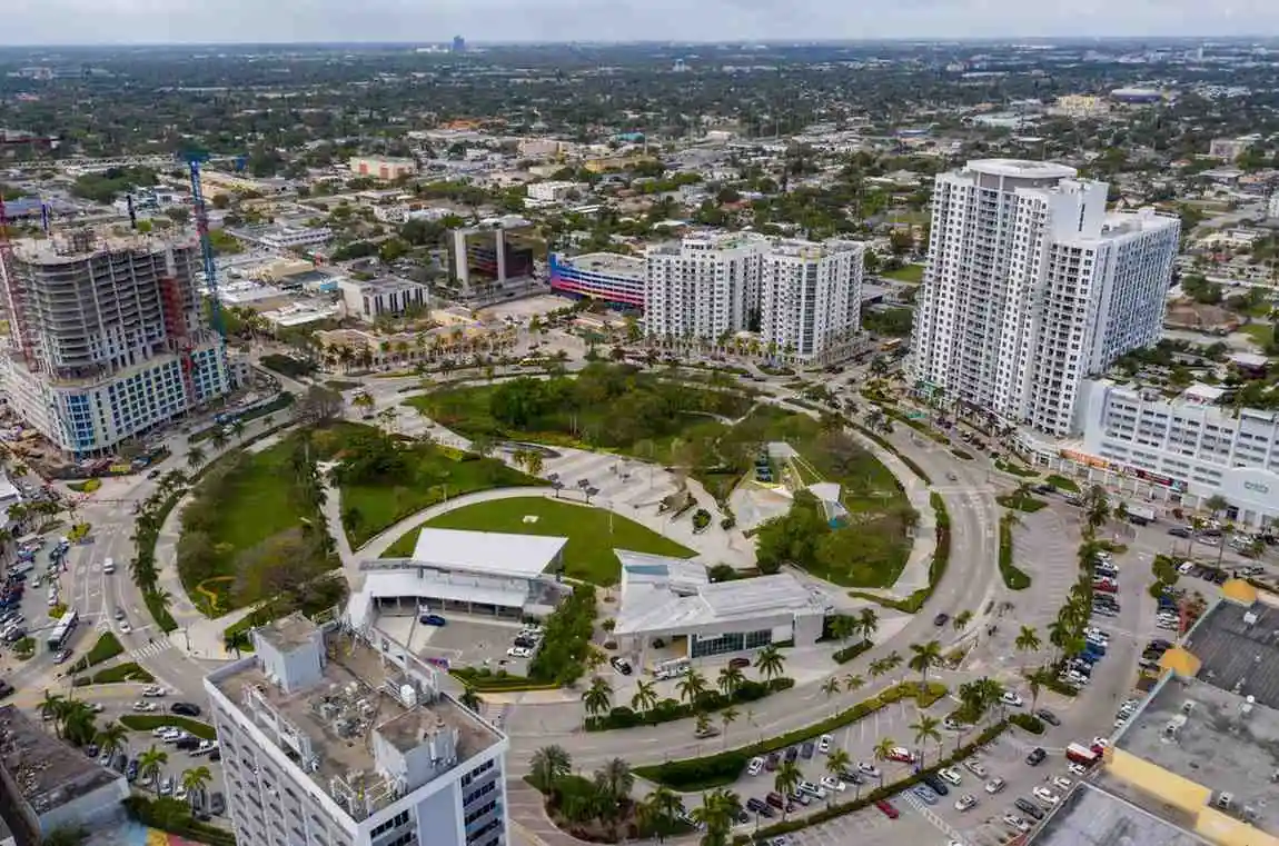 Aerial view of prime city locations featuring a large circular park surrounded by modern high-rise buildings and busy streets.