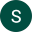 A white capital letter "S" centered on a dark green circular background, inspired by Daniel Robinson's minimalist design approach.