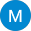 A blue circle with a white, uppercase letter "M" in the center, designed by Isaac Kassab.