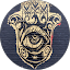 Gold Hamsa hand with an eye design in the center, set against a dark circular background.